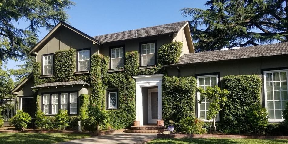 Residential home with new roof installed and company poster in yard