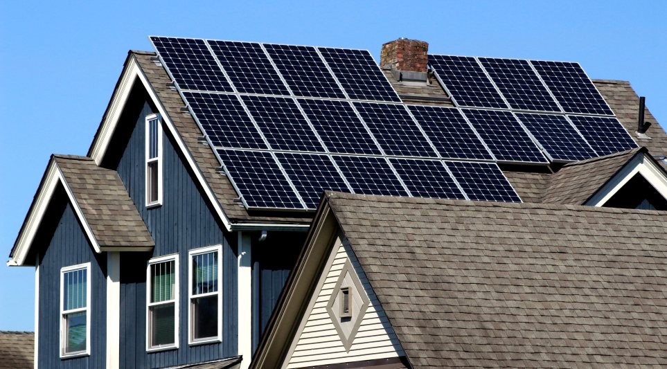 Residential home with new roof installed and company poster in yard